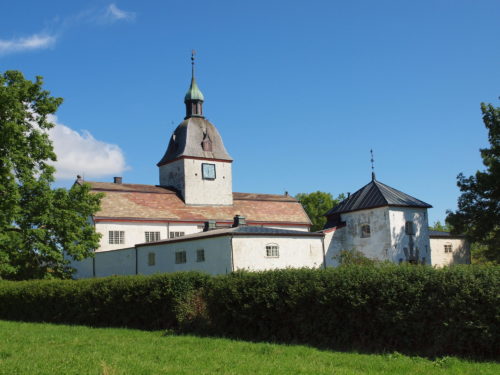 Ørland, Austrått manor, white manor with a belfry with a spire, blue sky.
